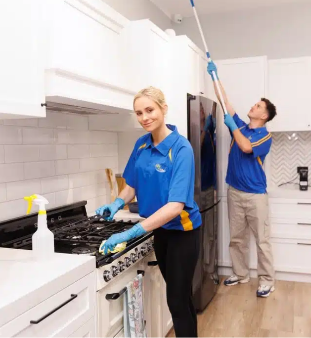 Professional cleaners cleaning the range and kitchen ceiling