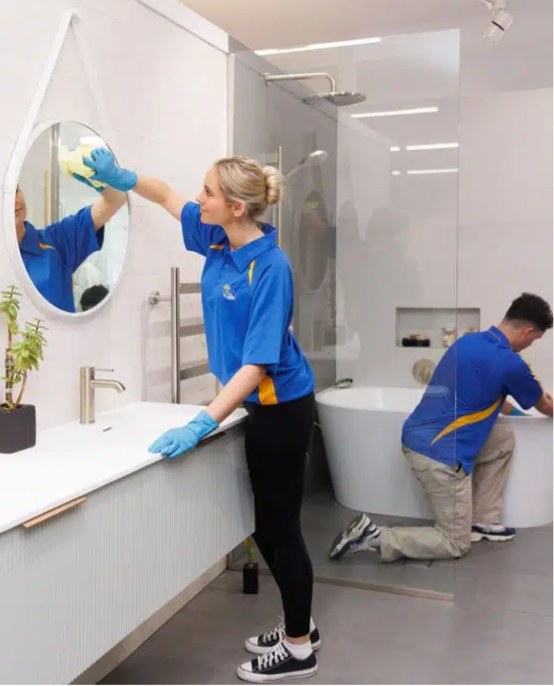 Professional workers cleaning a bathroom