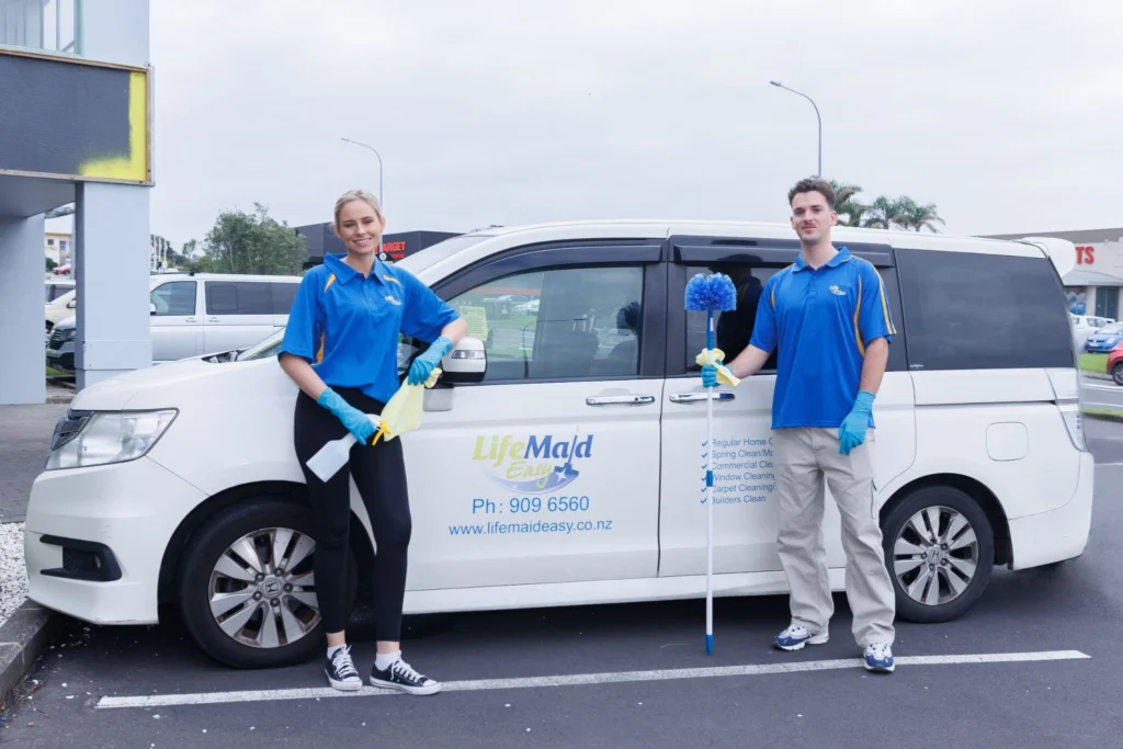 Two professional cleaners from Life Maid Easy posing for a photo in front of the company van